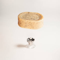 Bar of soap on a white pedestal with a white background