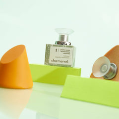 Chamarrel product on a green stand with orange and yellow objects in the foreground