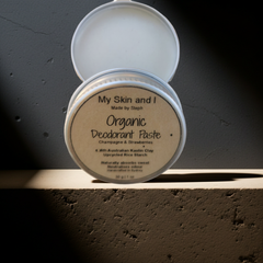 Organic deodorant paste container with lid open on a dark surface
