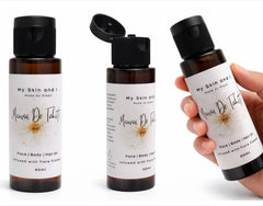 Three bottles of 'My Skin and Me' product with a hand holding one bottle.